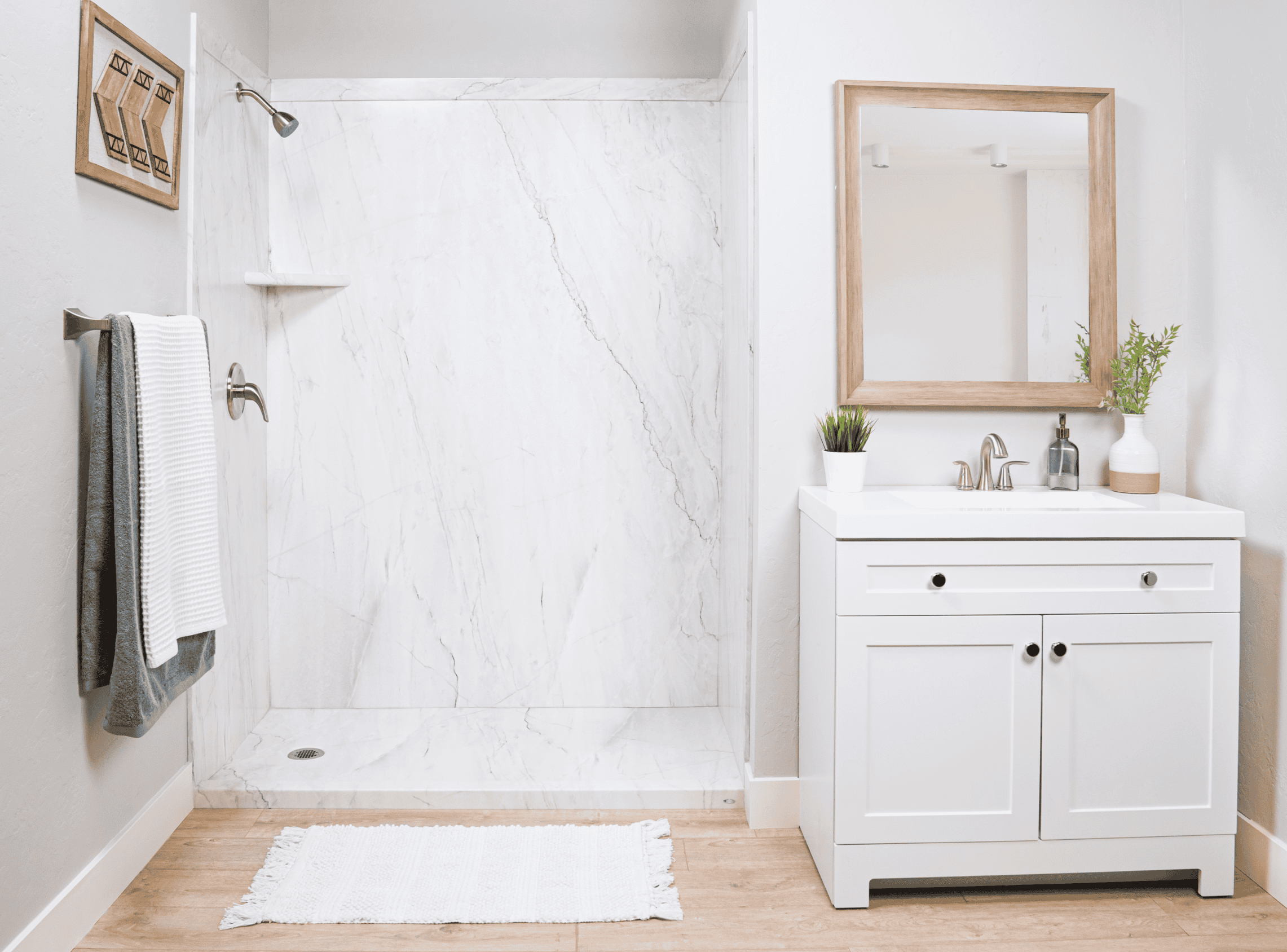 Bathroom with walk-in shower, white vanity, and minimalist decor.