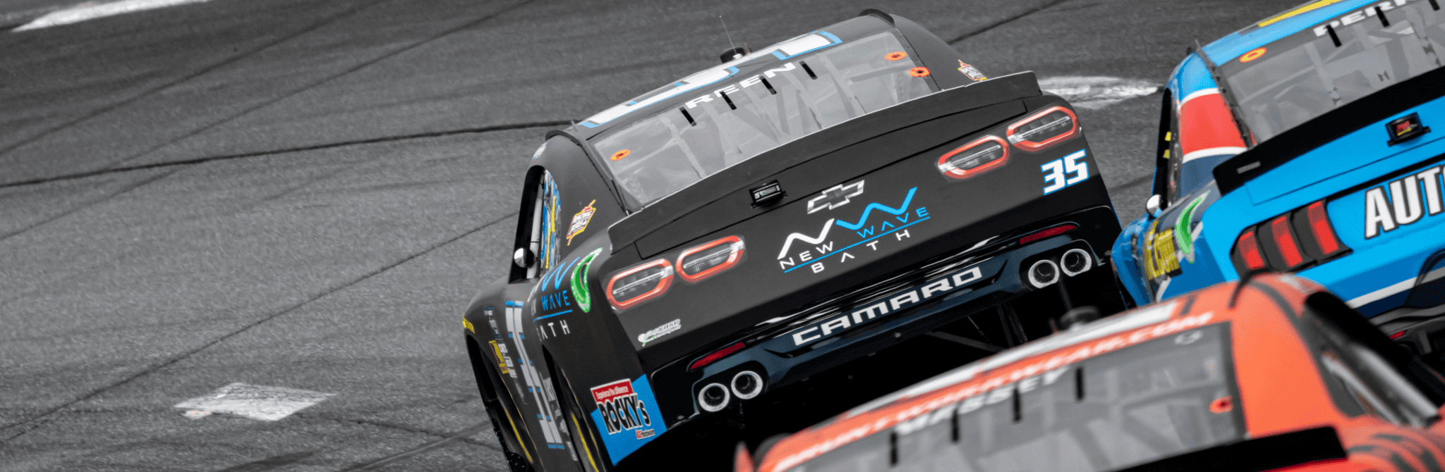 High-speed race cars on the track, showcasing sleek designs and vibrant colors at a professional rac.