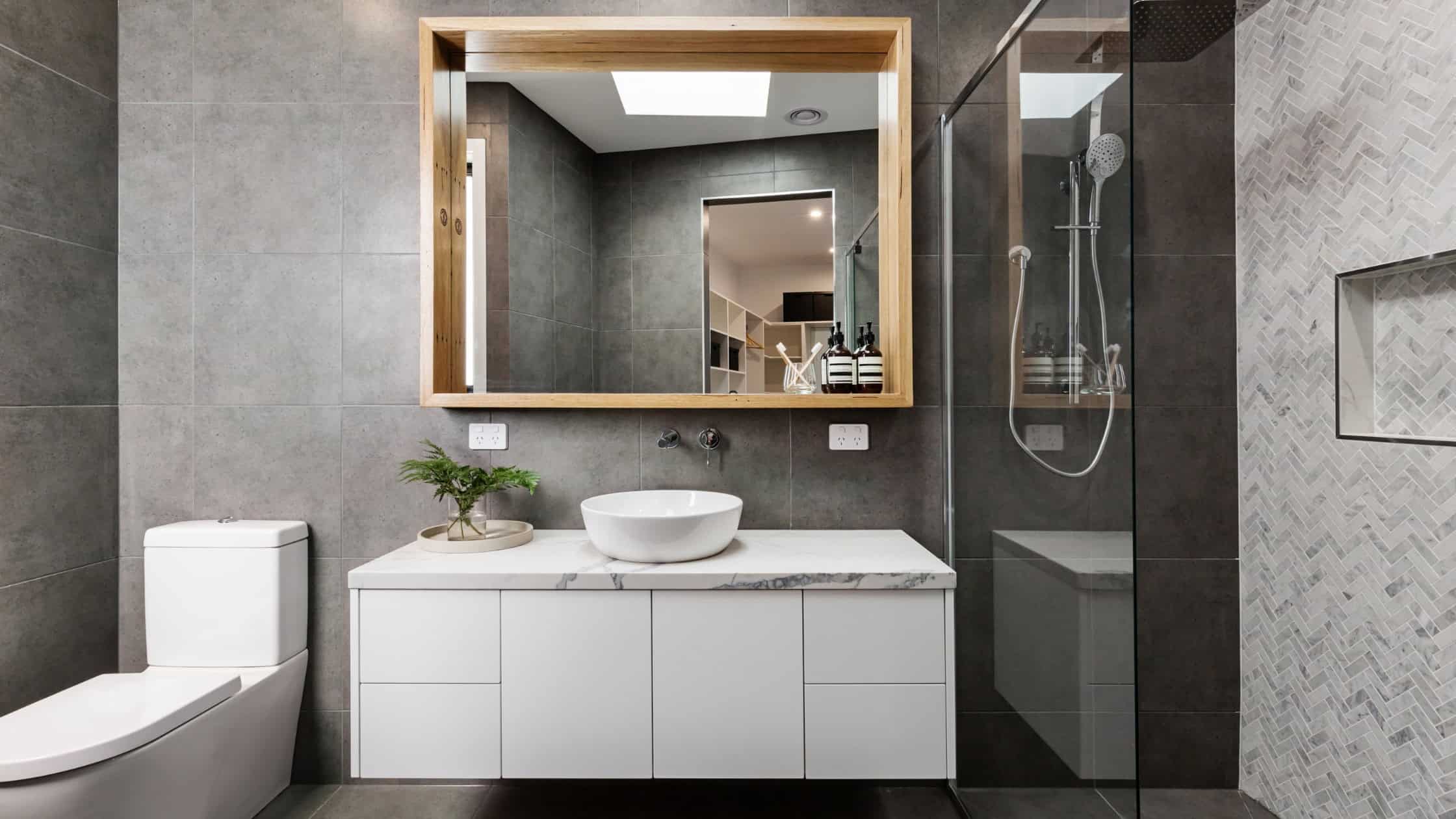 Modern bathroom with sleek vanity, vessel sink, and walk-in shower for contemporary style.