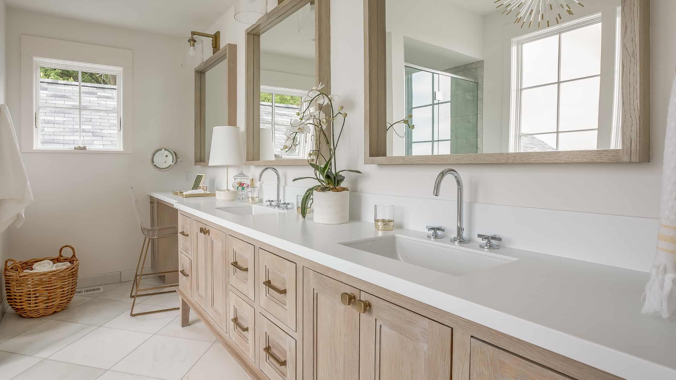 Elegant bathroom vanity with dual sinks and large mirrors.