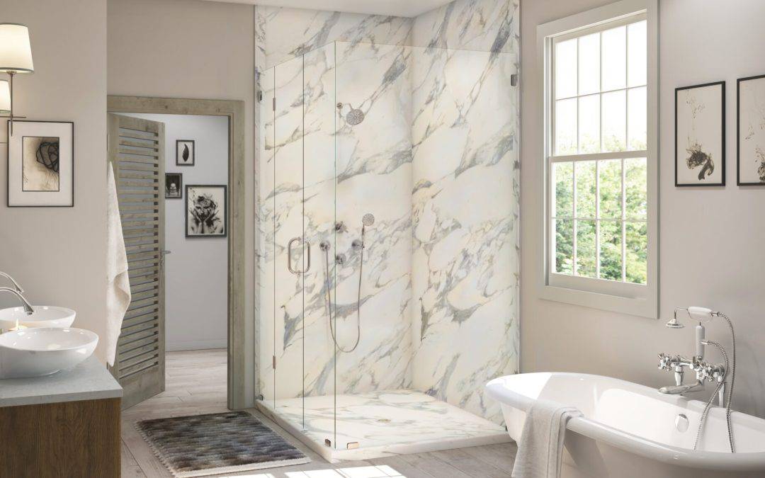 Elegant bathroom with marble shower and freestanding bathtub in a bright, modern space.