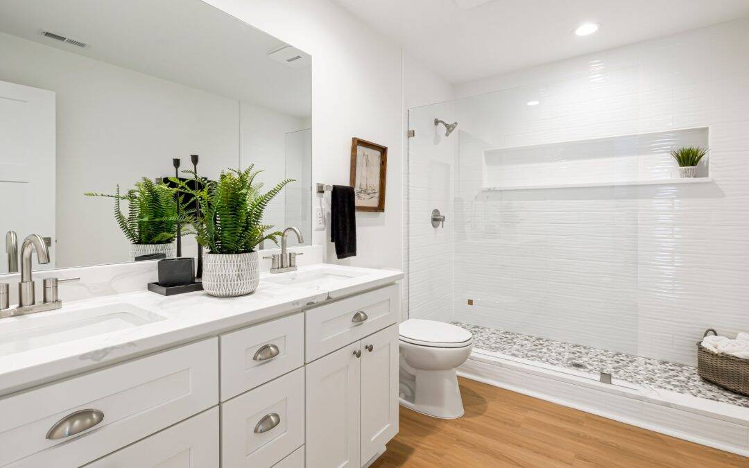 Modern white bathroom with double vanity, large mirror, and walk-in shower.