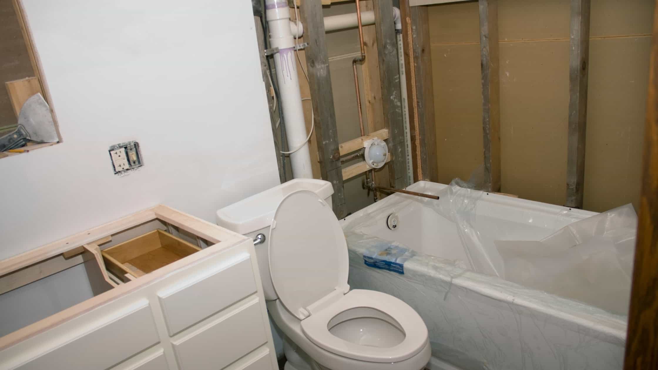 New Wave Bath installation with toilet and bathtub in a renovation project.