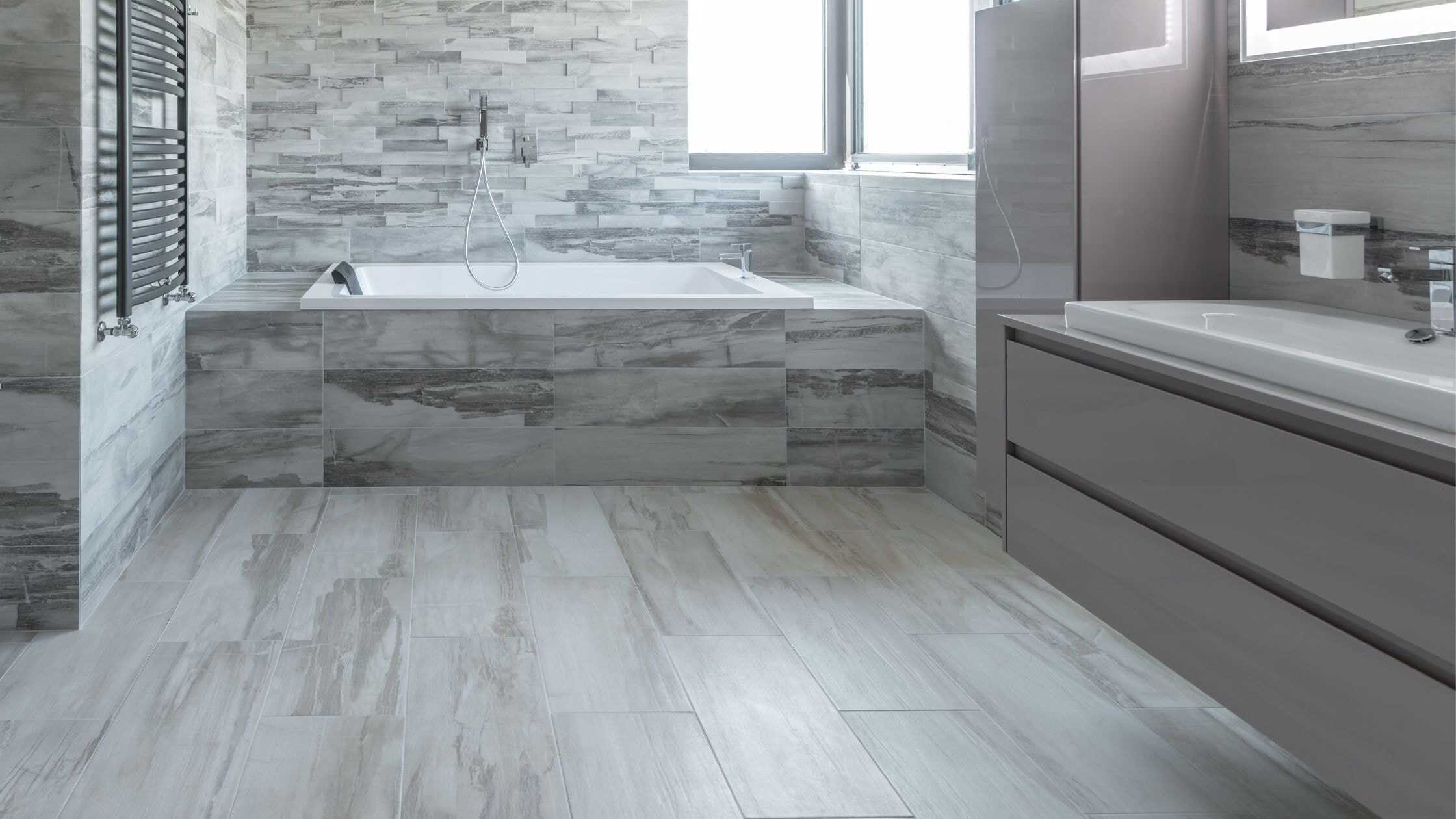 Elegant bathroom with a bathtub and sleek vanity in a contemporary style. Perfect for a luxurious an.