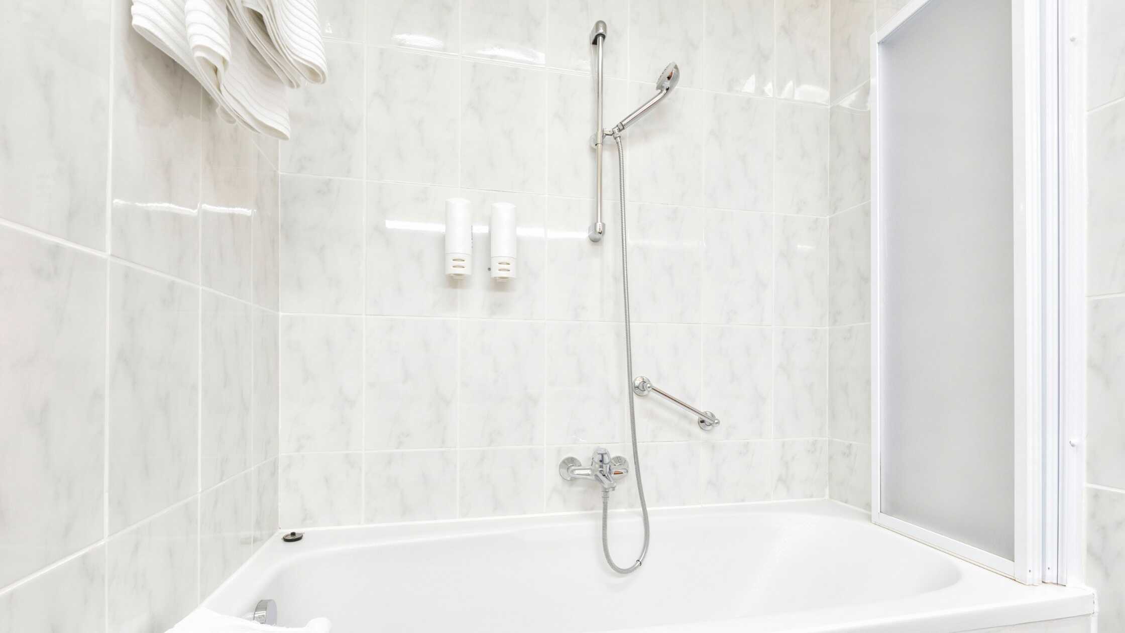 Accessible bathroom with walk-in tub and grab bars for safety and comfort.