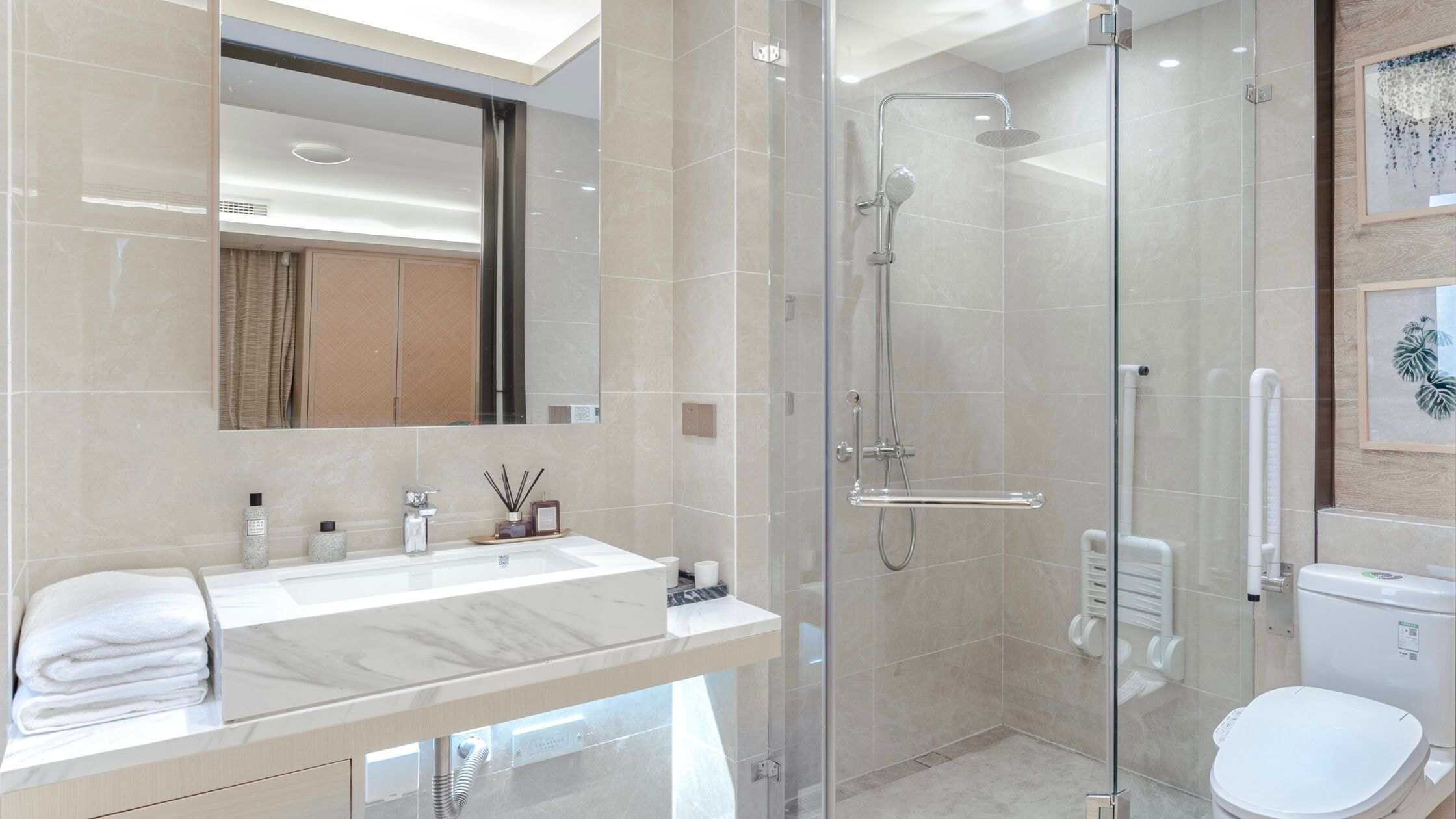 Elegant bathroom with walk-in shower, vanity, and modern fixtures in a luxury home.