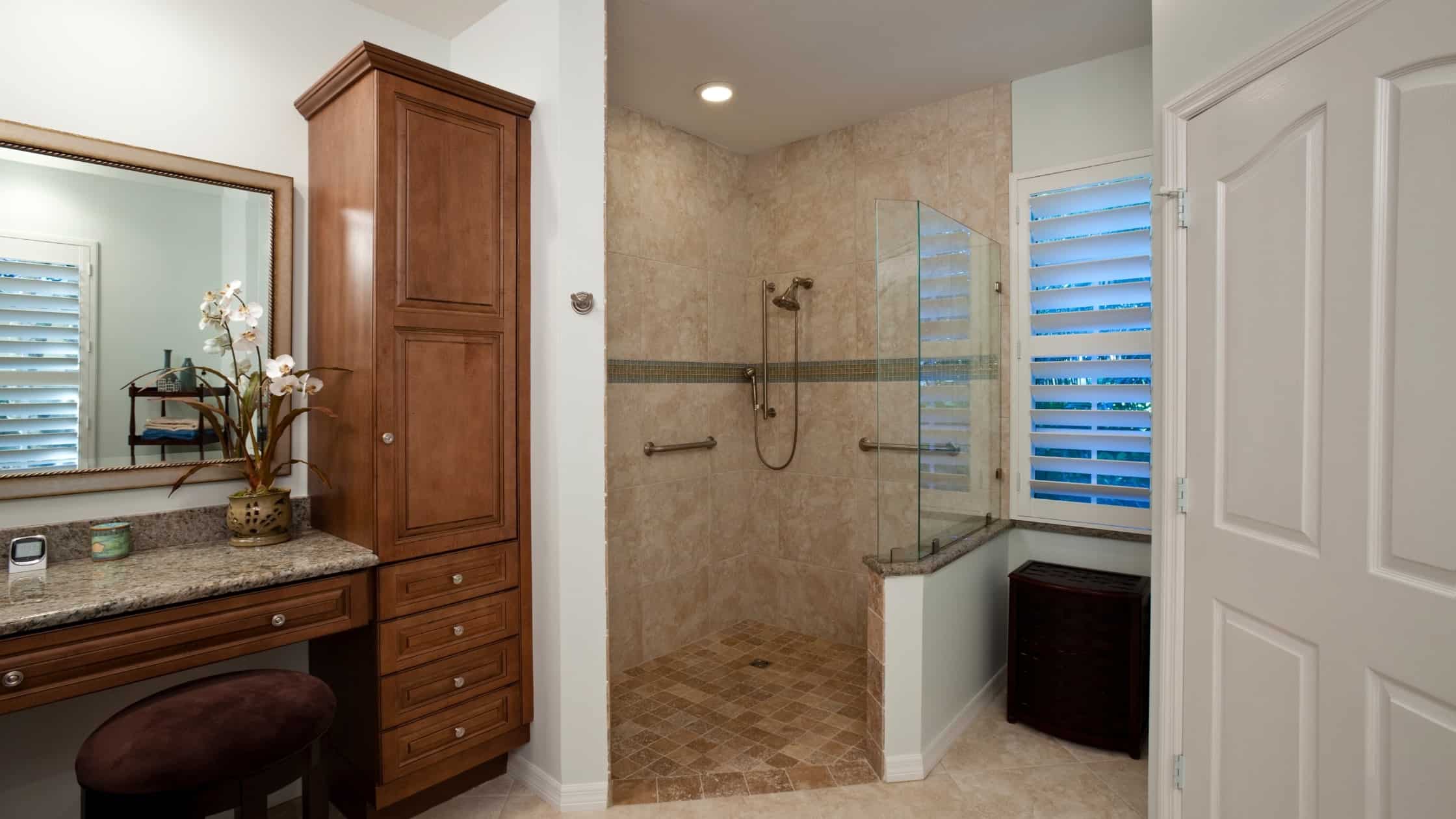 Accessible bathroom with walk-in shower and grab bars for safety.