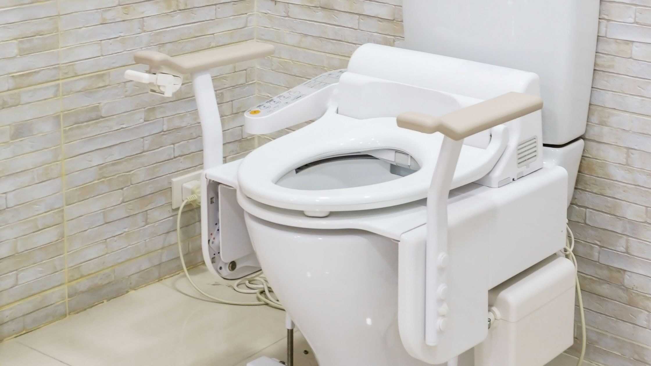 Advanced medical toilet with support arms for enhanced hygiene and accessibility.