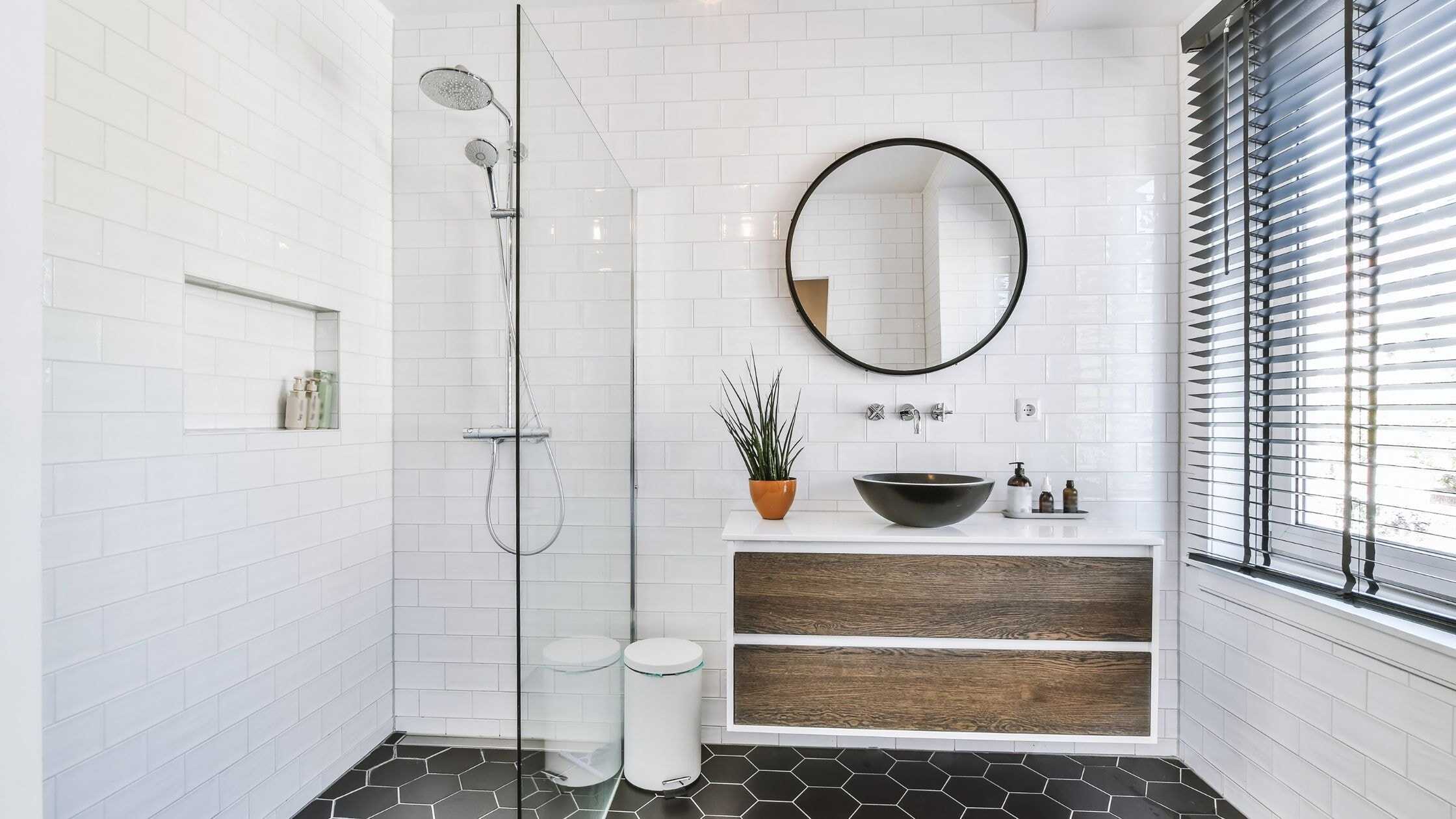 Modern bathroom with walk-in shower, black sink, and stylish decor for a sleek look.