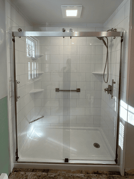Modern glass shower door with sliding mechanism.