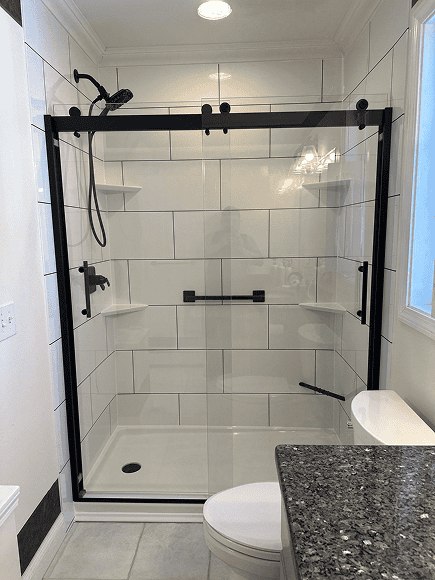 New Wave Bath Shower Modern glass shower enclosure with black hardware.