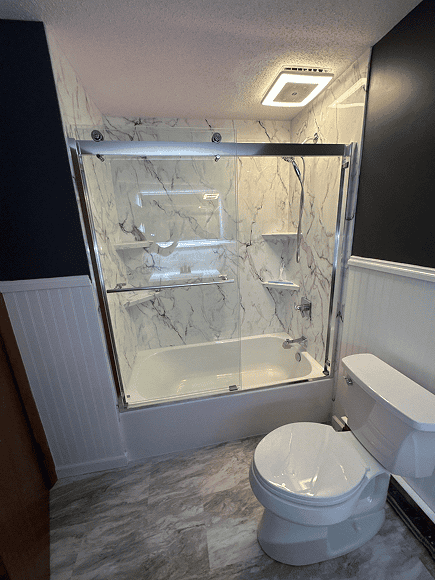 Elegant bathroom with a marble shower enclosure and modern fixtures.